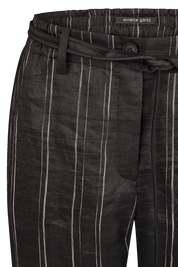 Black/white pants with an elastic waistband and tie belt.
