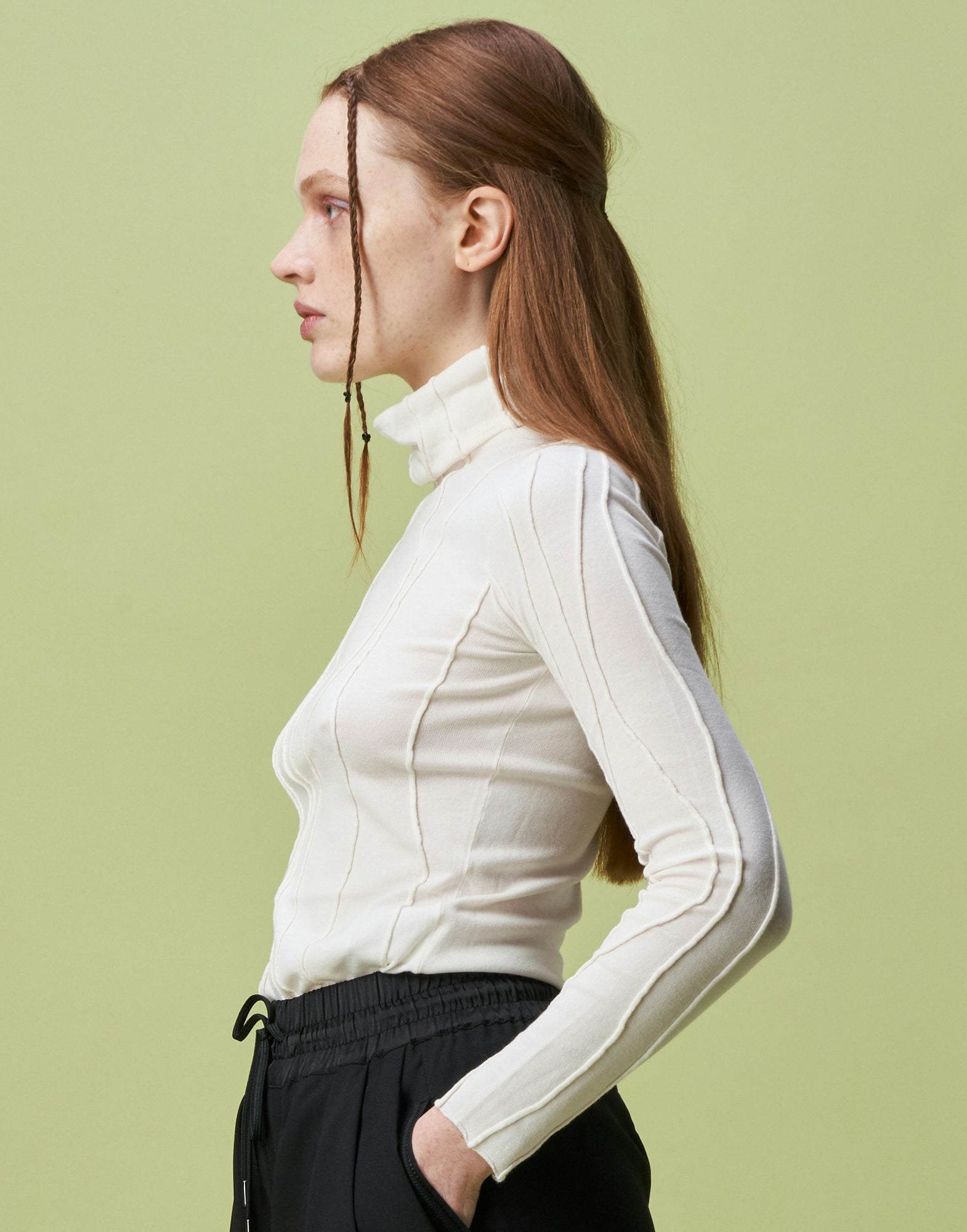 Arrogant Ivory Rollneck sweater with raised and curved seams