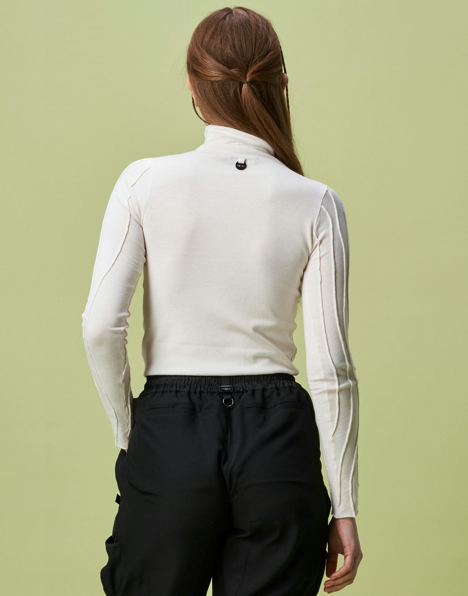 Arrogant Ivory Rollneck sweater with raised and curved seams