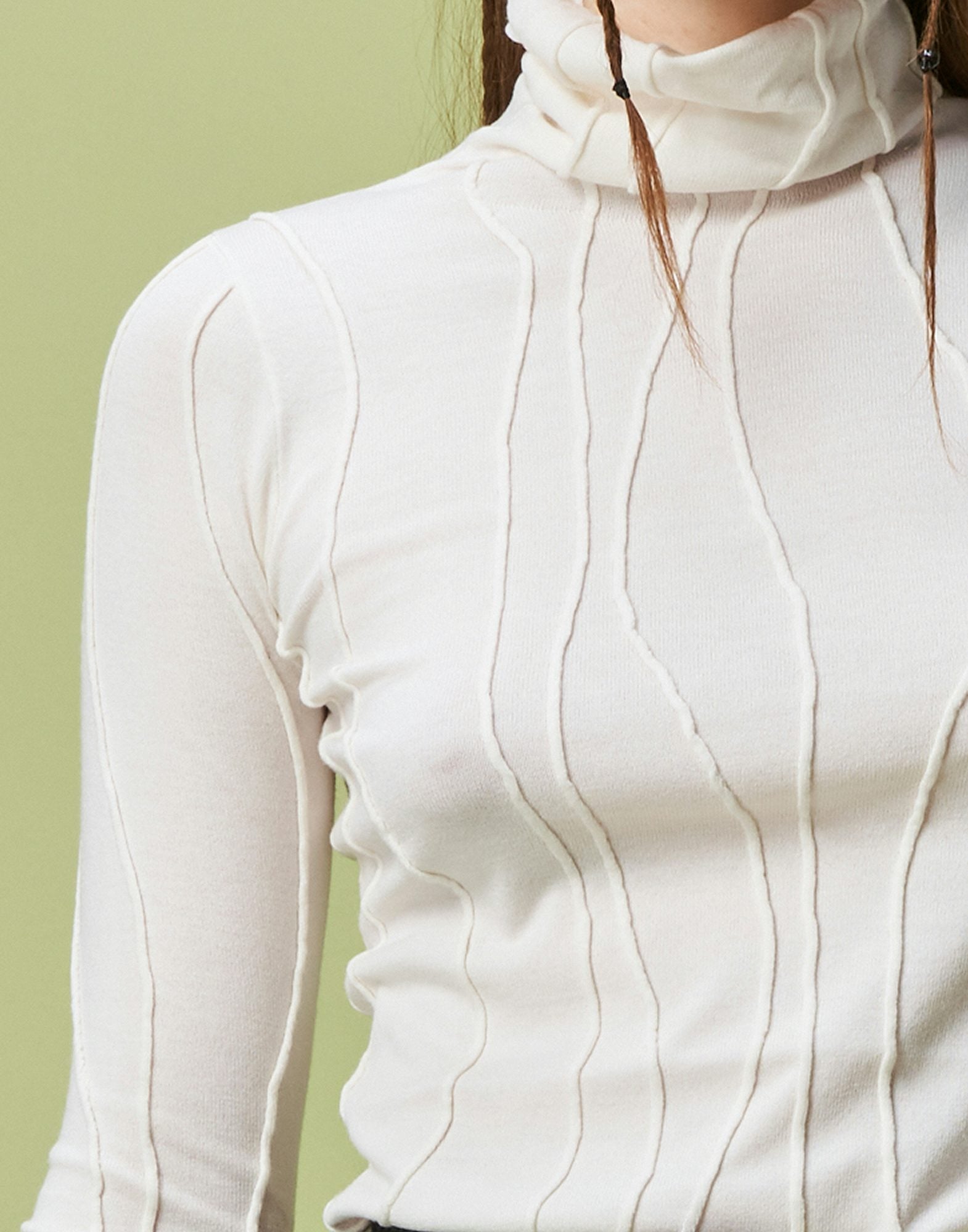 Arrogant Ivory Rollneck sweater with raised and curved seams