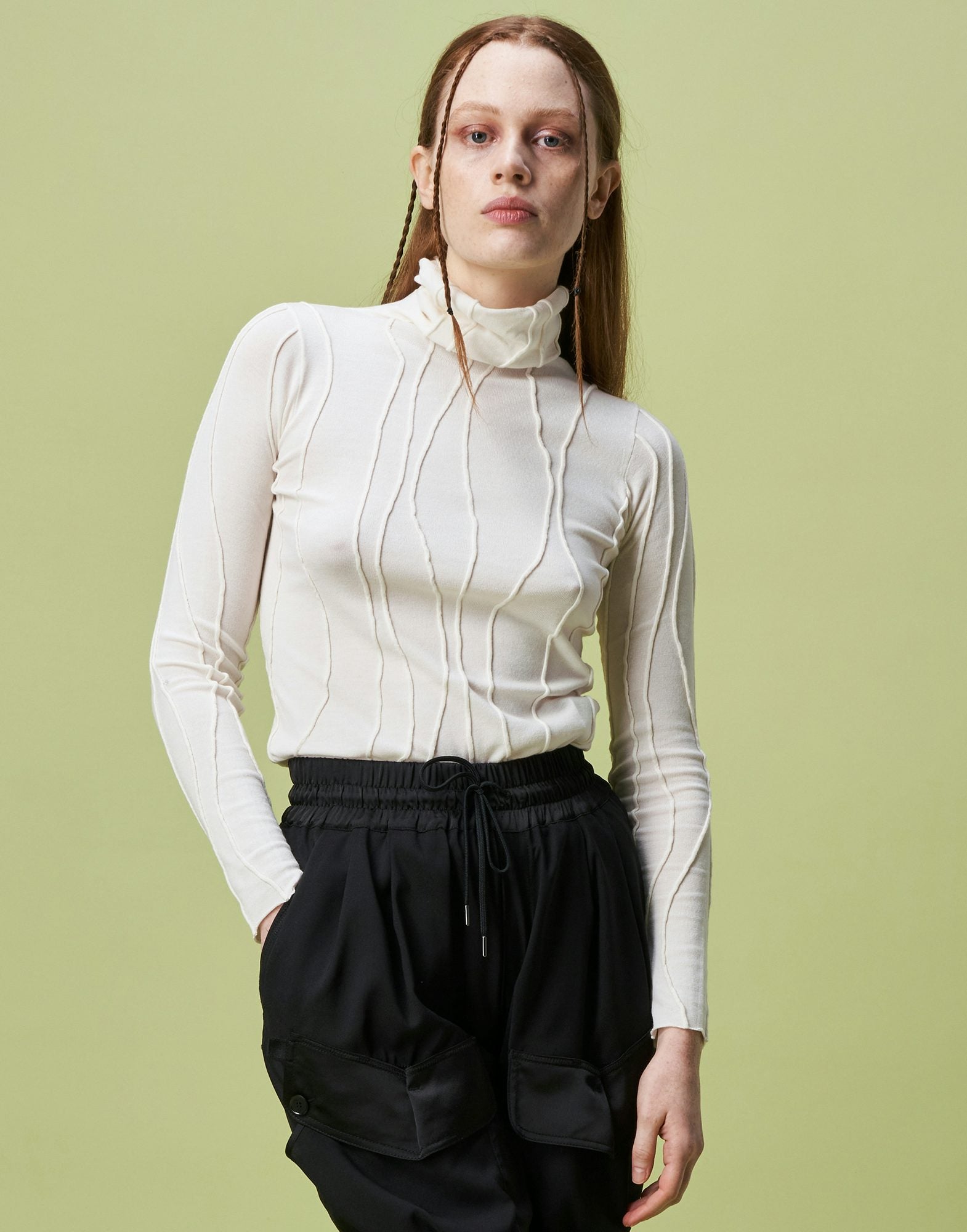 Arrogant Ivory Rollneck sweater with raised and curved seams